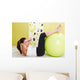 Beauty, young girl behooves gym exercise with ball Wall Mural