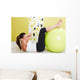 Beauty, young girl behooves gym exercise with ball Wall Mural