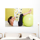 Beauty, young girl behooves gym exercise with ball Wall Mural