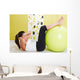 Beauty, young girl behooves gym exercise with ball Wall Mural