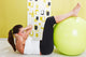 Beauty, young girl behooves gym exercise with ball Wall Mural