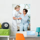 Nurse helps a patient to get up in hospital Wall Mural