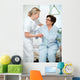 Nurse helps a patient to get up in hospital Wall Mural