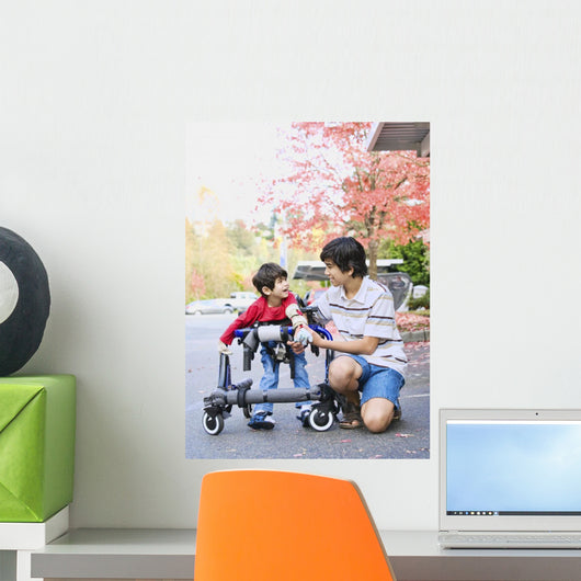 Teen boy with disabled little brother in walker Wall Mural