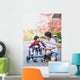 Teen boy with disabled little brother in walker Wall Mural