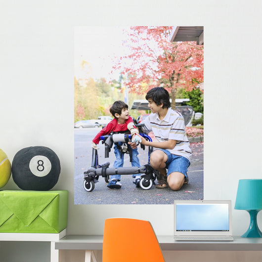 Teen boy with disabled little brother in walker Wall Mural