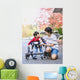 Teen boy with disabled little brother in walker Wall Mural
