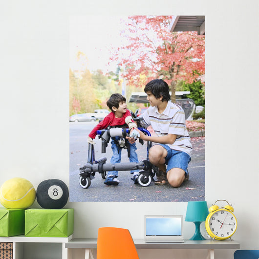 Teen boy with disabled little brother in walker Wall Mural
