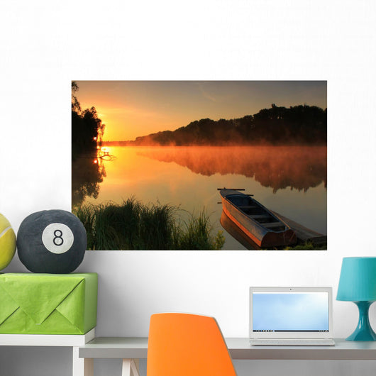Boat on the shore of a misty lake Wall Mural