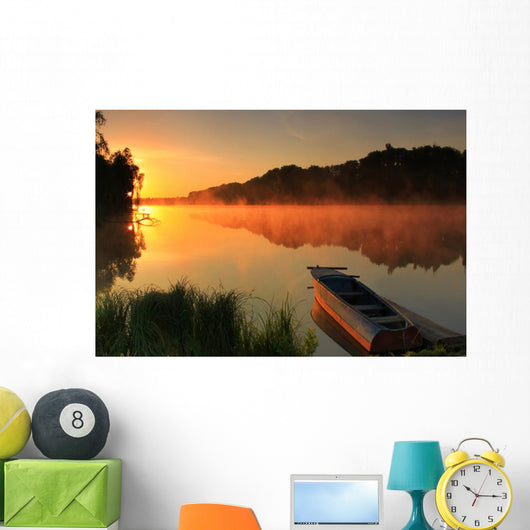 Boat on the shore of a misty lake Wall Mural