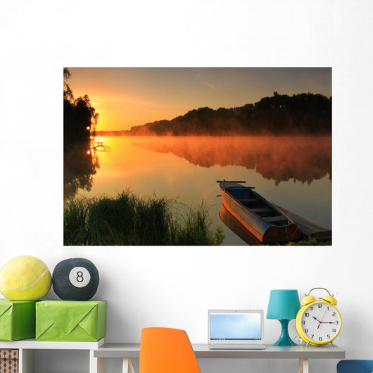 Boat on the shore of a misty lake Wall Mural