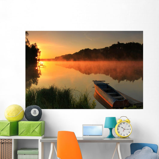 Boat on the shore of a misty lake Wall Mural