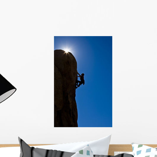 Rock climber clinging to a cliff. Wall Mural