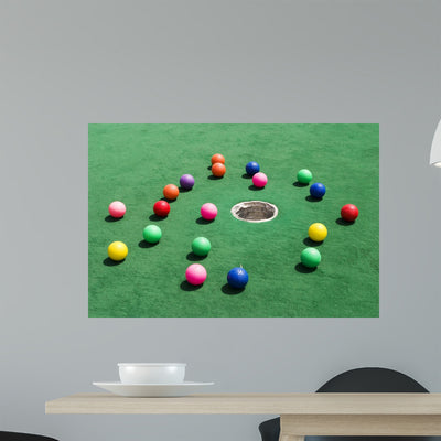 Scattered Golf Balls Wall Mural shown on a wall