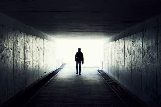 Silhouette of Man Walking in Tunnel Wall Mural