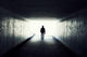 Silhouette of Man Walking in Tunnel Wall Mural