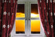 Sunset through a secure window with curtains Wall Mural