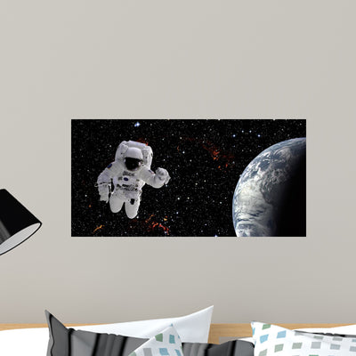 Astronaut Space Wall Mural shown on a wall