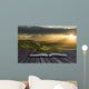 Magical book with contents spilling into landscape background Wall Mural