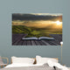 Magical book with contents spilling into landscape background Wall Mural