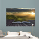 Magical book with contents spilling into landscape background Wall Mural