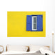 Colorful yellow house with blue shutters in Governor's Harbour Wall Mural