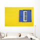 Colorful yellow house with blue shutters in Governor's Harbour Wall Mural