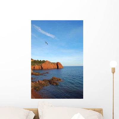 Seagull Flying Over Water Wall Decal shown on a wall