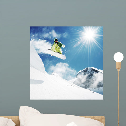 Snowboarder at jump inhigh mountains Wall Mural