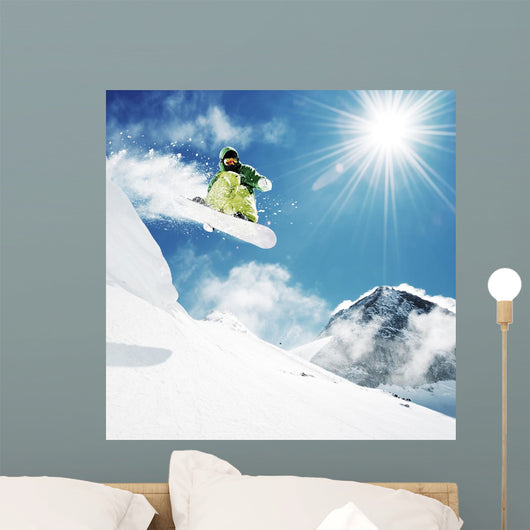 Snowboarder at jump inhigh mountains Wall Mural