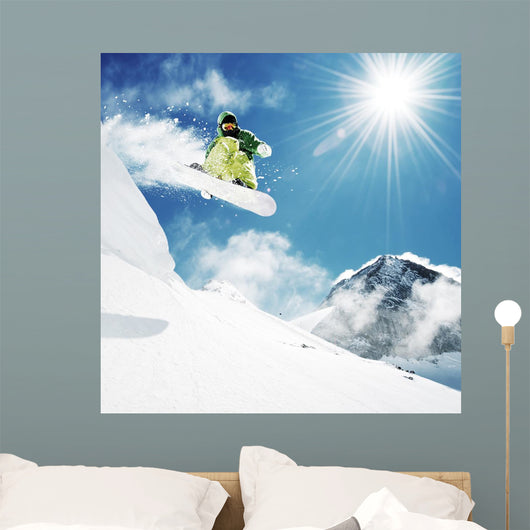 Snowboarder at jump inhigh mountains Wall Mural