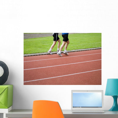 Two Men Running shown on a wall