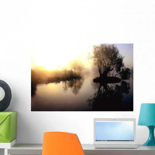 dramatic sunrise over a misty lake at dawn Wall Mural