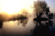 dramatic sunrise over a misty lake at dawn Wall Mural
