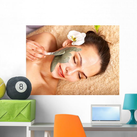 Young woman  having clay body mask. Wall Mural
