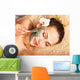 Young woman  having clay body mask. Wall Mural