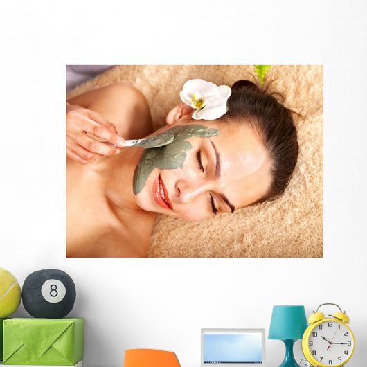Young woman  having clay body mask. Wall Mural