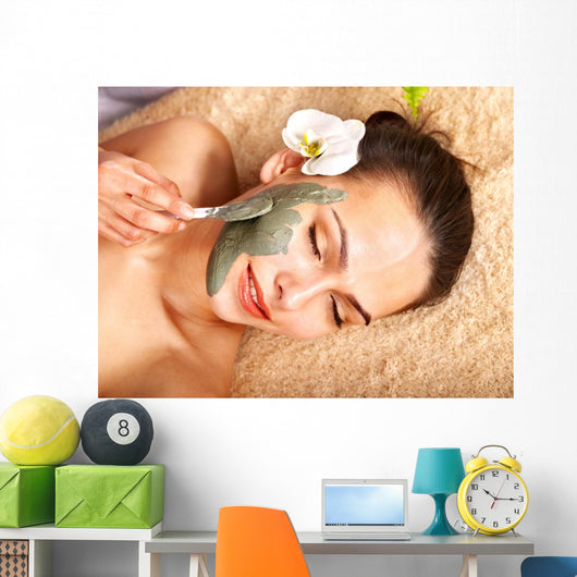 Young woman  having clay body mask. Wall Mural