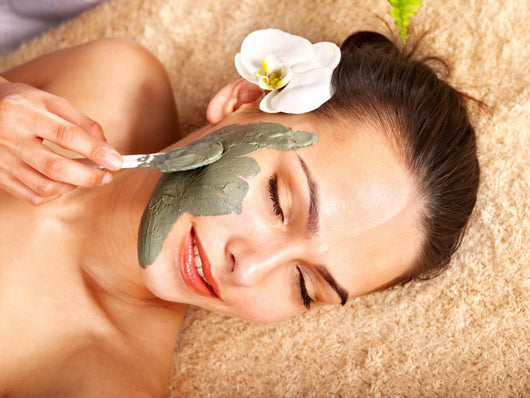 Young woman  having clay body mask. Wall Mural