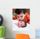Young Boy Talking to His Newborn Sister Wall Mural