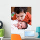 Young Boy Talking to His Newborn Sister Wall Mural