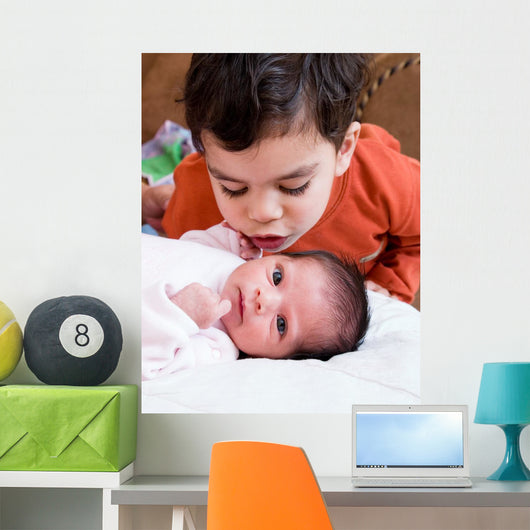 Young Boy Talking to His Newborn Sister Wall Mural