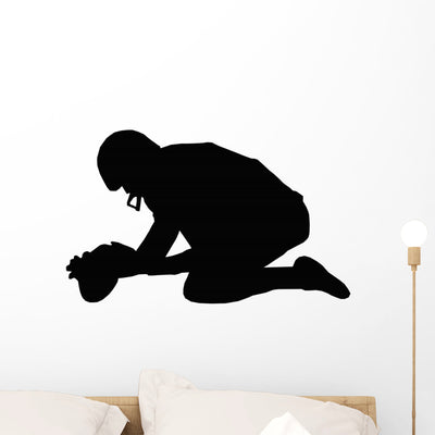 Silhouette American Football Holder Wall Decal shown on a wall