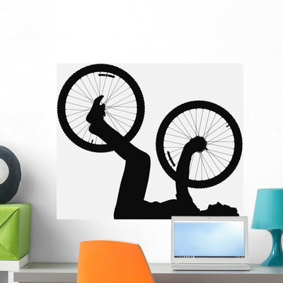 Silhouette Person Holding Bicycle Wall Decal shown on a wall