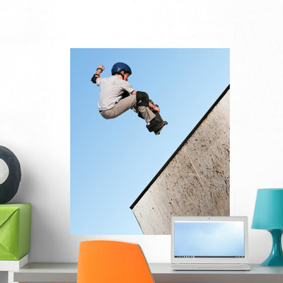 Boy Skateboarding Wall Mural shown on a wall