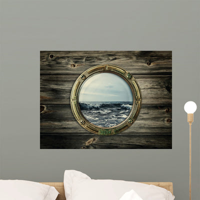 Old Ship Porthole Looking Over Ocean Wall Decal shown on a wall
