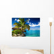 Tropical bungalow and palm tree next to amazing lagoon Wall Mural