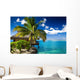 Tropical bungalow and palm tree next to amazing lagoon Wall Mural