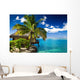 Tropical bungalow and palm tree next to amazing lagoon Wall Mural