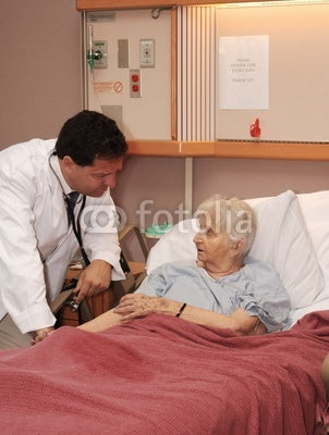 doctor taking senior blood pressure Wall Mural